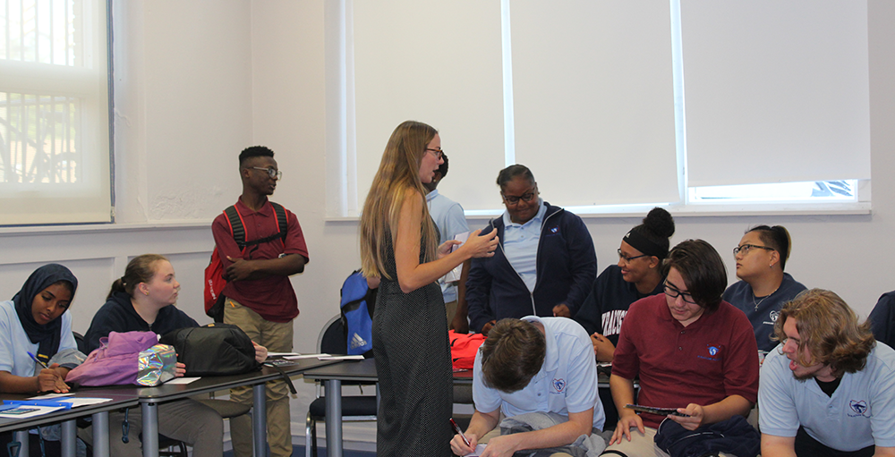 New York University's Assistant Director of Admissions, Aurora Kearney, speaks with Junior and Senior Atoms
