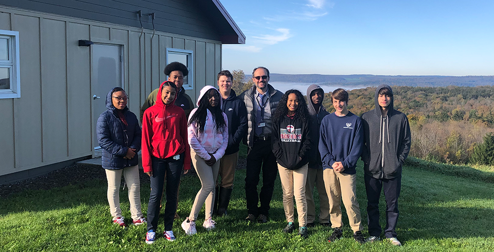 High school Atoms enjoy a field trip to SUNY ESF’s Hieberg Memorial Forest, where they learned about logging and forest ecology