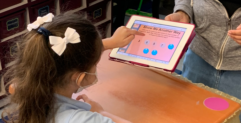 Kindergarten Atoms incorporate technology into their math lesson.