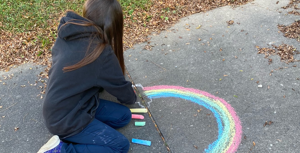 Syracuse Academy of Science fourth grade Atoms decorate the sidewalks with chalk on a warm November day.