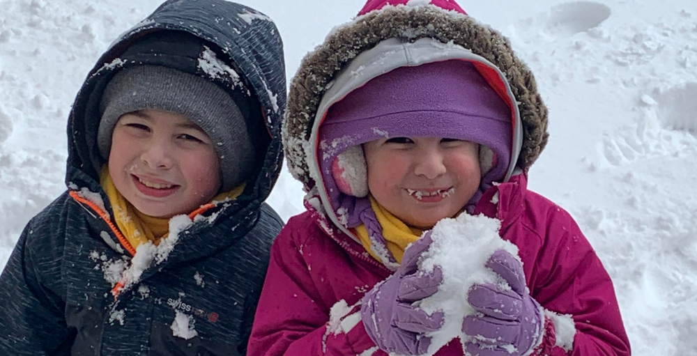Elementary Atoms siblings enjoy a day in the snow after completing their daily online assignments for their first snow day of the year.