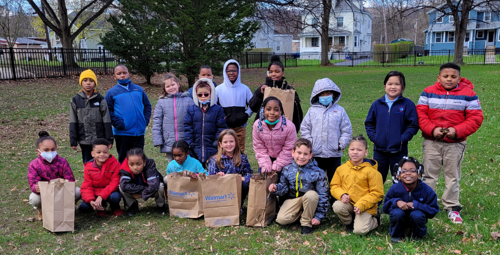 Syracuse Academy of Science elementary school students celebrate the 52nd Earth Day by helping clean up the campus & learn how they can make an impact in their community.