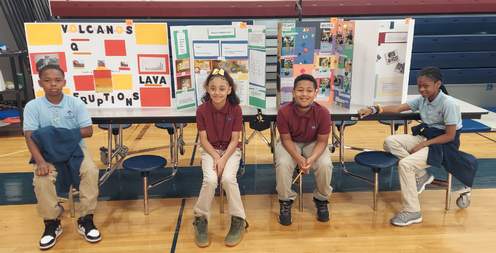 Syracuse Academy of Science middle school students created poster boards and presented on science fair or world religion topics in their end-of-year Academic Fair.