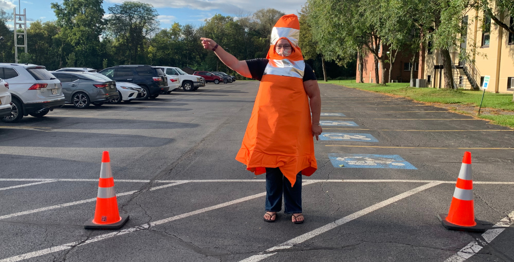 Syracuse Academy of Science elementary school teacher, Ms. A-B dressed as a traffic cone to ‘reroute’ a little fun, laughter and excitement to the Atoms and their families.