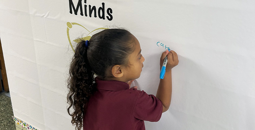 Mrs. Miller Adds Students' Names to Marvelous Minds Wall